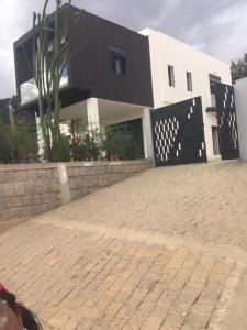 a house with a brick driveway in front of it at Villa Alexandra in Antananarivo