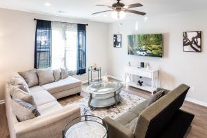 a living room with a couch and a table at Brand-new home close to LSU campus in Baton Rouge