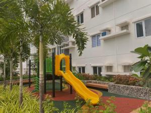 a playground with a slide in front of a building at Condo • WIFI up to 100mbps • Pool • Netflix&Chill in Cebu City