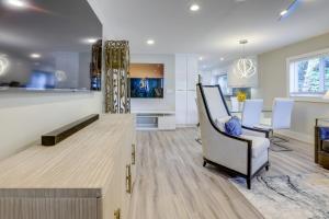 a living room and dining room with a table and chairs at 2 Blocks to Riviera Beach Upscale Condo with Patio in West Palm Beach