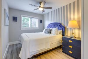 a bedroom with a blue bed and a window at 2 Blocks to Riviera Beach Upscale Condo with Patio in West Palm Beach