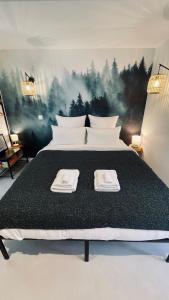 a bedroom with a bed with two towels on it at Le Chalet de la Plage in Sévrier