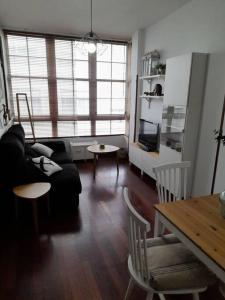 a living room with a couch and a table at Apartamento pleno centro Ferrol. in Ferrol