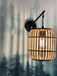 a light hanging from a ceiling with trees in the background at Le Chalet de la Plage in Sévrier