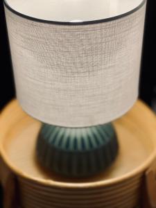a stack of plates on a table with a lamp at Le Chalet de la Plage in Sévrier