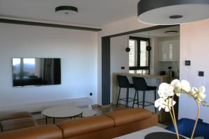 a living room with a couch and a bar at Apartment Terezija in Dubrovnik