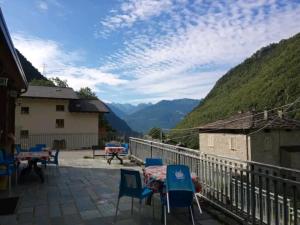 a view from the balcony of a house with a table and chairs at Terra e Radici_ Betula in Spriana