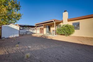 a house with a dirt driveway in front of it at Adobe Home in Albuquerque with Covered Patio in Albuquerque