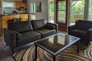a living room with a couch and a coffee table at Stark Mountain Sanctuary in Waitsfield