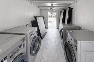 a laundry room with two washing machines in it at Sea Grape Getaway in Marathon