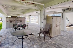 a patio with a table and chairs on it at Sea Grape Getaway in Marathon
