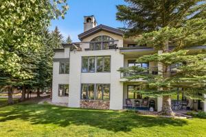 an exterior view of a large house with trees at Seasons Lodge #101 in Edwards