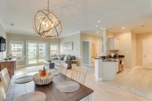 a kitchen and living room with a table and chairs at 3 Mi to Folly Beach Condo with Pool Access! in Charleston