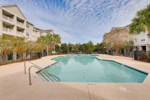 a swimming pool in a apartment complex with condos at 3 Mi to Folly Beach Condo with Pool Access! in Charleston