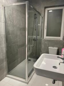 a bathroom with a shower and a sink at Msida Suites in Msida