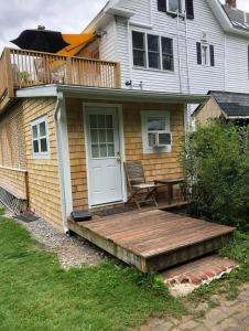 a house with a wooden porch and a deck at The Notch Hostel in North Woodstock