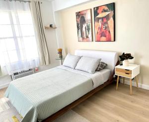 a bedroom with a bed and a picture on the wall at High-End Apartment, Across the Beach in Miami Beach