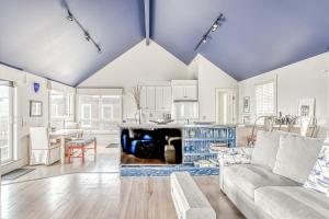 a living room with a couch and a table at Cannon Beach Saltbox Cottage in Cannon Beach