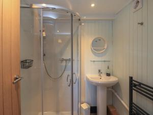 a bathroom with a shower and a sink at Doune Bay Lodge in Mallaig