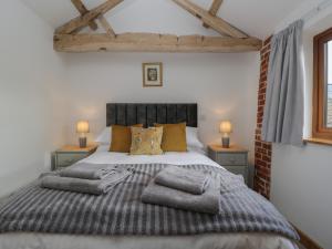 a bedroom with a large bed with pillows on it at The Cow Shed in Worcester
