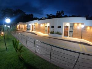 a house with a fence in front of it at night at Pousada Flor de Alter in Alter do Chao