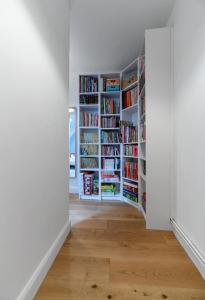 an empty room with white bookshelves at Grande Maison Cusset - Maison de ville - 3 chambres in Cusset
