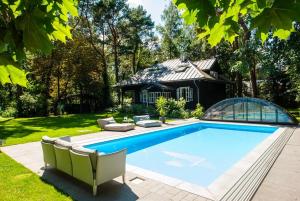 a swimming pool in the yard of a house at Joy Village in Warsaw