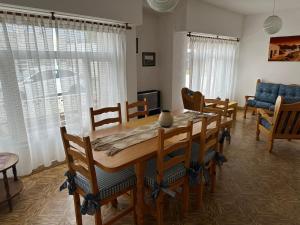 a dining room with a wooden table and chairs at La casa de Chola in Playa Unión