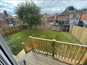 a view of a yard from a balcony at Rawmarsh - Great Customer Feedback - 2 Bed Bungalow - New Build - High End Furnishings - Wheel Chair Accessible - Large Enclosed Garden - Dog Friendly in Rotherham