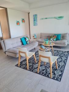 a living room with two chairs and a couch at Beautiful Beach Apartment in Zazue in Santa Marta