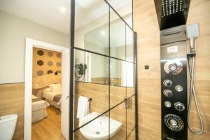 a bathroom with a shower with a toilet and a sink at Hotel Monasterio Granada - Adults Only in Granada +92 photos