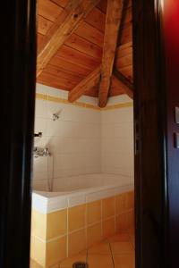 a bath tub in a bathroom with a wooden ceiling at Diminio 1 Whole House - Chalet in Arachova +19 photos