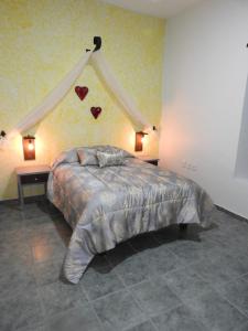 a bedroom with a bed with hearts on the wall at Mesón del Alcalde in Lagos de Moreno