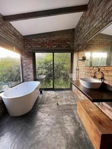a bathroom with two sinks and a large tub at Brickhouse in Monteray