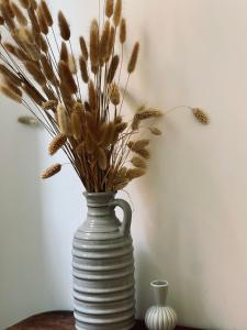 a white vase with flowers in it on a table at Le Chalet de la Plage in Sévrier