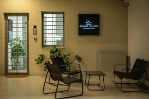 a waiting room with chairs and a sign on the wall at Athens Genesis Luxury Suites in Athens