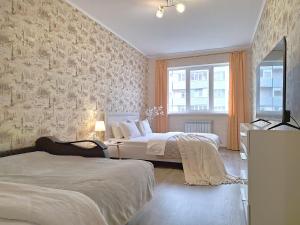 a bedroom with two beds and a brick wall at Синя квартира. Мережа Alex Apartments. Цілодобове безконактне заселення 24-7 in Poltava