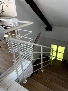 a white spiral stair case in a room with stairs at Magnifique appartement de charme in Besançon