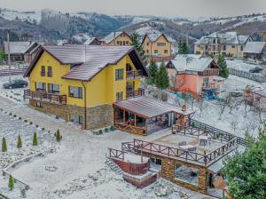 an aerial view of a house in a village at Transylvanian Views in Peştera