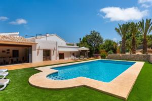 an image of a swimming pool in the backyard of a house at Villa Joan - PlusHolidays in Calpe