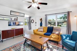 a living room with a couch and a table at Boho Villa 10 mins from Siesta in Sarasota