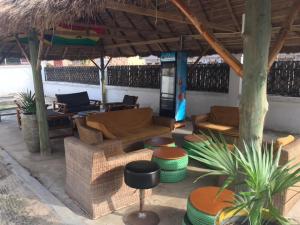 a living room with couches and chairs under a pavilion at Nana's Holiday Let in Accra