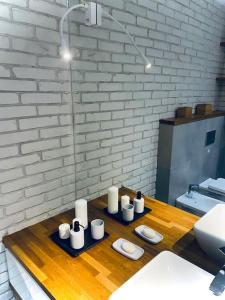a bathroom with a table with white candles on it at KOMFORTOWY,JASNY APARTAMENT dla max 4-5 osób in Łódź