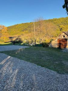 a gravel road with a barn on a hill at Cottage Sainte Marguerite in Gap