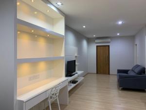 a living room with a blue couch and a television at 118 Apartment Tanjung Tokong by Yen's Sojourn in George Town