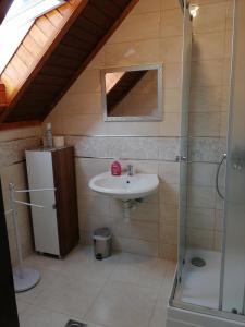 a bathroom with a sink and a shower at Fitt Vendégház in Sümeg