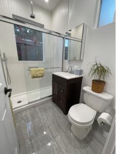 a bathroom with a toilet and a shower and a sink at Resort Getaway in Private Garden Terrace Villa w Luxury Amenities in Los Angeles