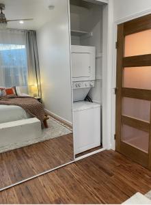 1 dormitorio con cama y espejo junto a una puerta en Resort Getaway in Private Garden Terrace Villa w Luxury Amenities en Los Ángeles