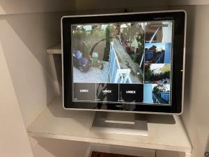 a television sitting on a shelf with a picture of a house at Resort Getaway in Private Garden Terrace Villa w Luxury Amenities in Los Angeles +21 photos