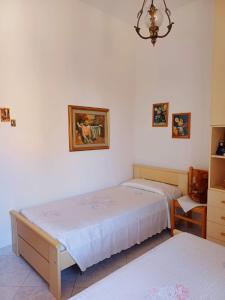 1 Schlafzimmer mit 2 Betten und einem Kronleuchter in der Unterkunft Casa Ciusa in Quartu SantʼElena